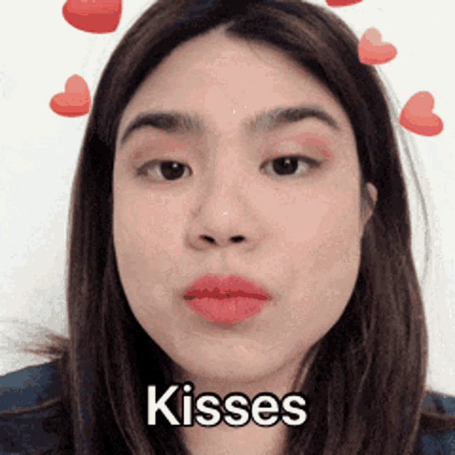 a close up of a woman 's face with the words kisses written on it