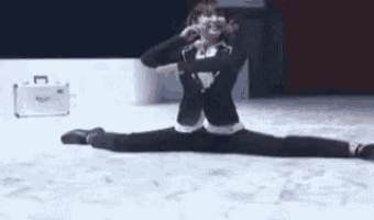 a woman is doing a split on a stage .