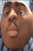 a close up of a cartoon character 's face with a big head .