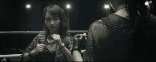 two women are standing in a boxing ring talking