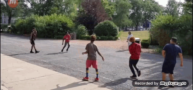 a group of people are playing basketball in a parking lot and the video is recorded by mobizen