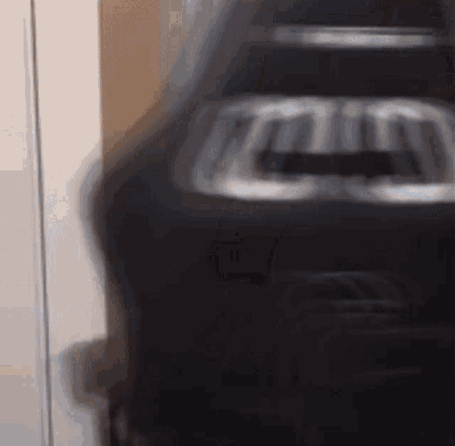 a blurred image of a toaster that says ' t ' on it
