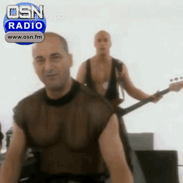 a man playing a guitar in front of an osn radio advertisement