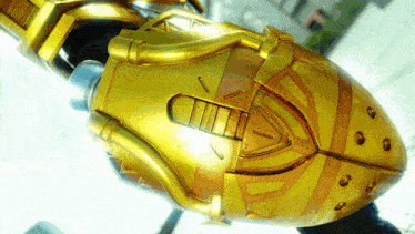 a close up of a gold object that looks like a rocket