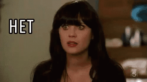 a woman with black hair and bangs is making a funny face .