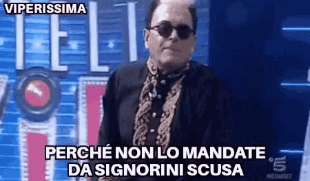 a man wearing sunglasses and a black shirt is standing in front of a sign that says " viperissima "