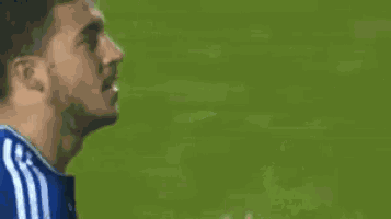 a soccer player is giving a high five while wearing a blue shirt .