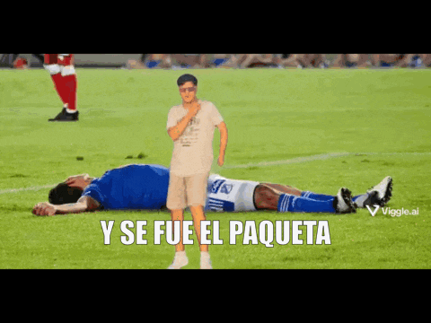 a man standing next to a soccer player laying on the field with the words y se fue el paqueta below him