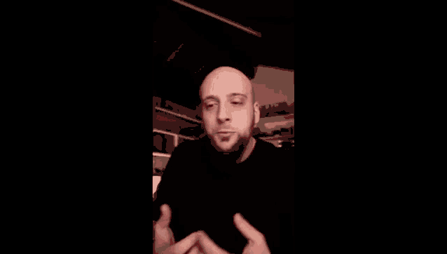 a bald man with a beard is making a funny face with the words rage di amore in red