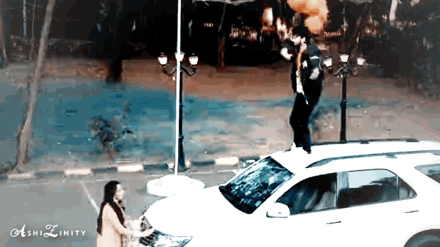 a man is standing on the roof of a car with ashizinity written on the bottom right
