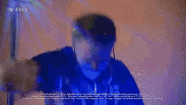 a blurred image of a person standing in front of a sign that says vivus .