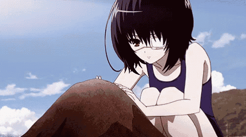 a girl in a swimsuit is sitting on a rock with a blue sky in the background .