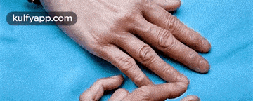 a close up of a person 's hand with the website kulfyapp.com visible