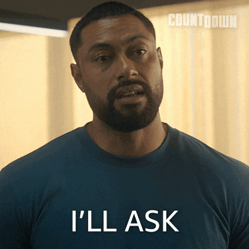 a man with a beard is wearing a blue shirt that says " i 'll ask "