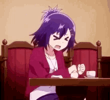a girl with purple hair is sitting at a table with a cup of coffee and making a funny face .