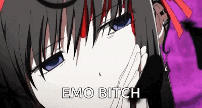 a girl with black hair and blue eyes is covering her face with her hand and says emo bitch .