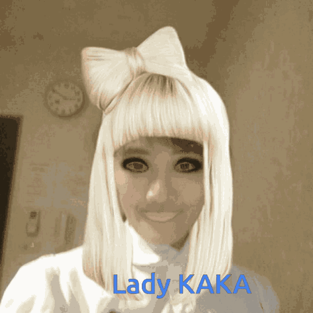a woman with a bow in her hair has the name lady kaka on her face