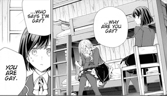 a girl is sitting on a bunk bed and talking to another girl who is sitting on a chair .