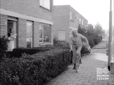 a black and white photo of a man riding a bike with the words sound & vision on the bottom right