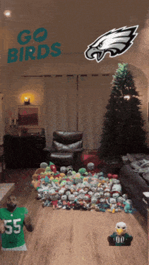a living room with a christmas tree and stuffed animals and the words go birds on the ceiling