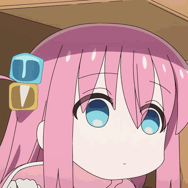 a girl with pink hair and blue eyes has a cube on her head with the letter u and v on it