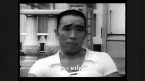 a man in a white shirt says boredom in a black and white video