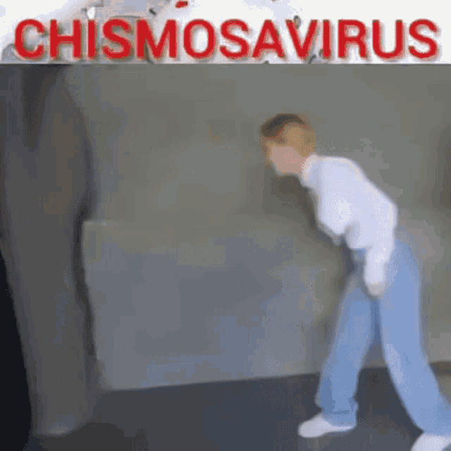 a woman is dancing in front of a wall with the words chismosaurus written on it .