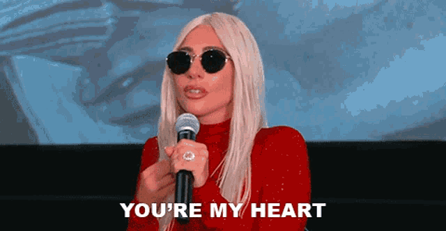 lady gaga is wearing sunglasses and holding a microphone and says you 're my heart