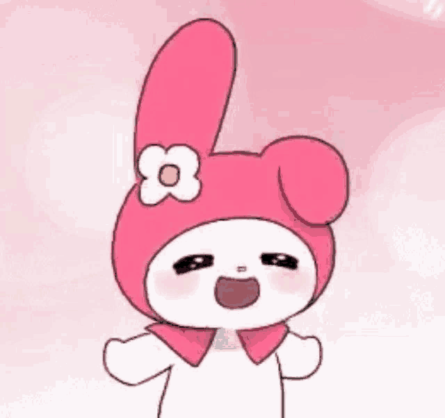 a pink bunny with a flower on its head is smiling .