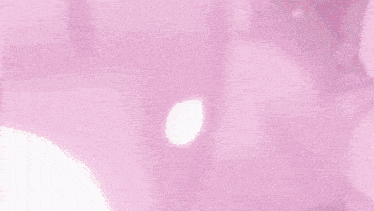 a close up of a person 's face with pink flowers coming out of it and the sun shining through it .
