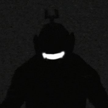 a silhouette of a teletubbies character with a big smile on his face in the dark .