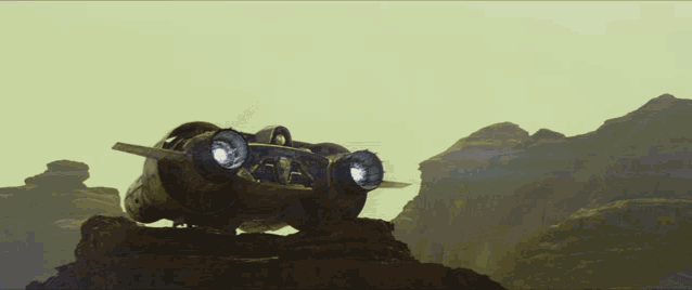 a futuristic vehicle is sitting on top of a rocky hill