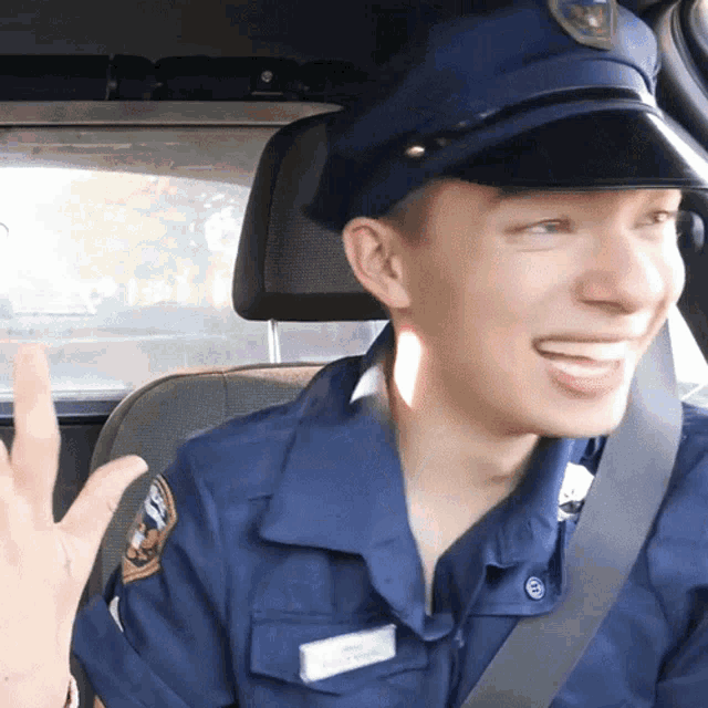 a man in a police uniform is smiling and wearing a name tag that says ' william ' on it
