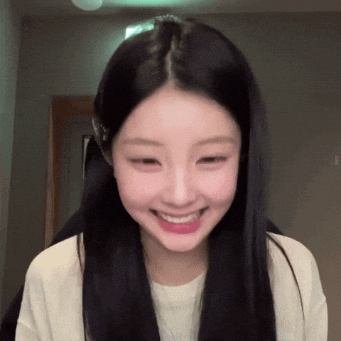 a woman with long black hair is smiling with her mouth open
