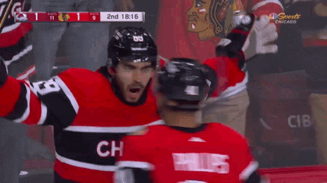 a hockey player in a red and black jersey with the number 33 on the back
