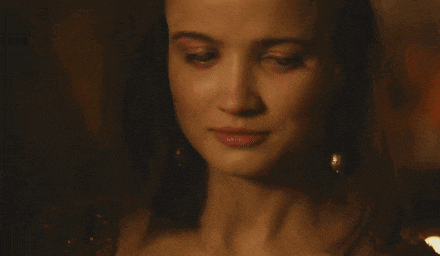 a close up of a woman 's face in a dark room with her eyes closed