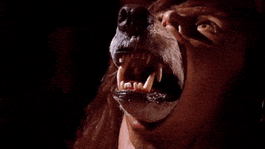 a close up of a werewolf 's mouth with its teeth visible