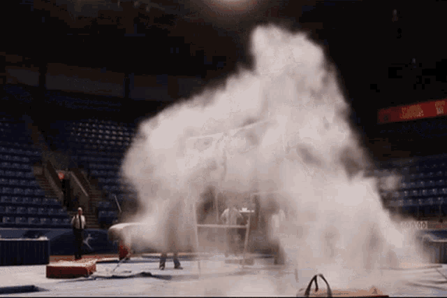 smoke is coming out of a gym with a scoreboard that says texas
