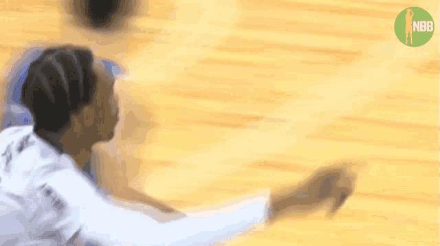 a blurry picture of a basketball player with a nba logo in the background