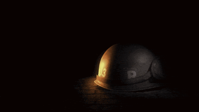 a helmet with goggles sits in the dark