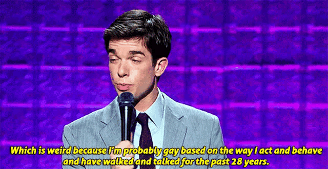 a man in a suit and tie is speaking into a microphone with the words which is weird below him