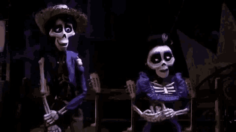 a couple of skeletons are standing next to each other in a dark room holding guitars .