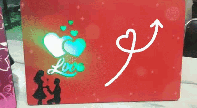 a red sign that says love and has hearts on it