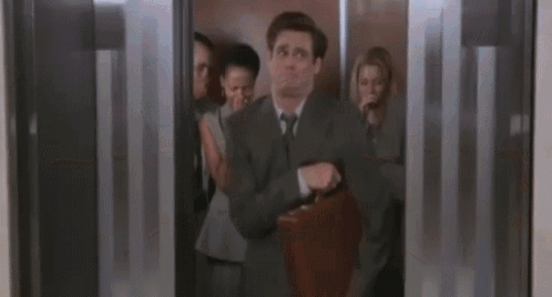 a man in a suit is walking in a room with a blurry background .