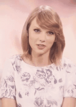 a close up of a woman 's face with a floral shirt on .