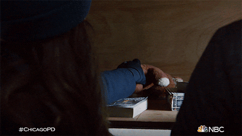 a woman in a blue beanie is holding a stuffed animal with the nbc logo on the bottom