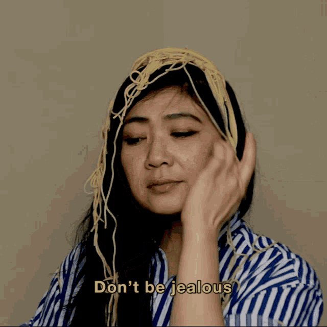 a woman with a bunch of noodles on her head says don 't be jealous
