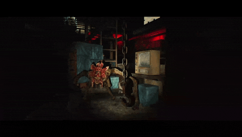 a monster is chained to a wall in a dark room next to a television