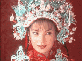 a close up of a woman wearing a crown on her head
