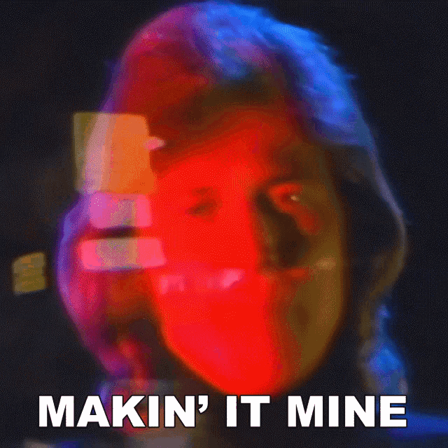a close up of a person 's face with the words makin ' it mine written below it